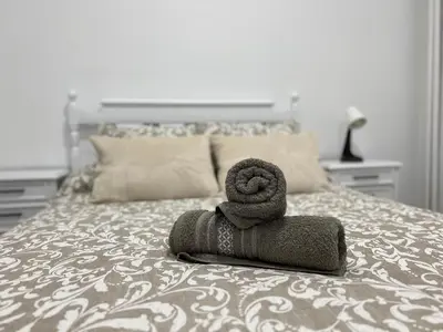 a pile of towels sitting on top of a bed at Piso Camino de Santiago in Sarria