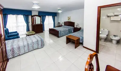 a hotel room with two beds and a bathroom at Hotel Restaurante Xaneiro in Melide