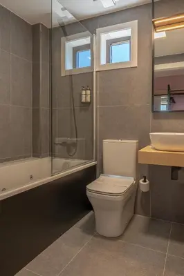 a bathroom with a toilet and a shower and a sink at HOTEL PORTOMARÍN STAR in Portomarin