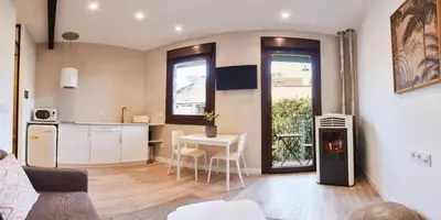 a bedroom with a bed and a table with a lamp at Villa Julia in Ribadavia