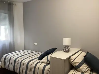 a bedroom with a bed and a lamp on a dresser at Rego de Flores in Viveiro