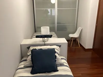 a living room with a chair and a large window at Rego de Flores in Viveiro