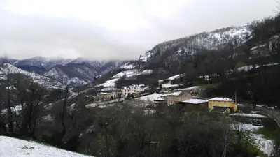 a village in the mountains with snow on the ground at Casa Gloria in Moncó