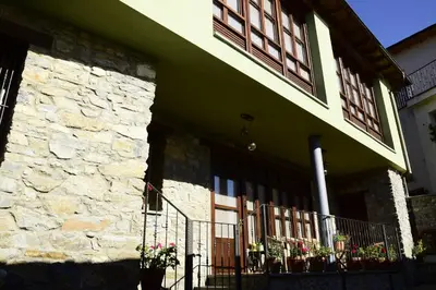 a green building with windows and a fence at Casa Gloria in Moncó