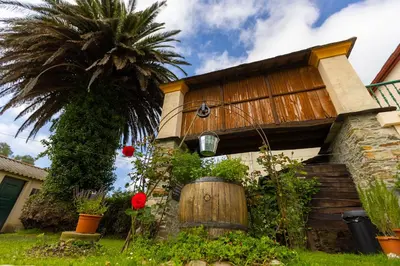 a house with a palm tree in front of it at Vivienda Vacacional Casa Fidel in Campas