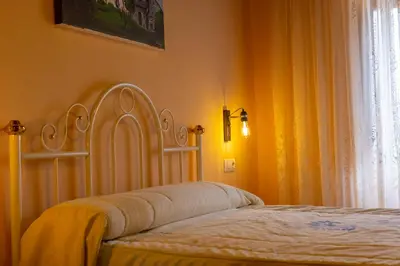 a bedroom with a bed with a white headboard and a window at Vivienda Vacacional Casa Fidel in Campas