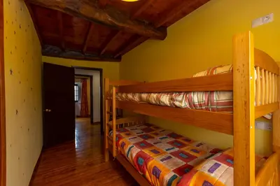 two bunk beds in a room with yellow walls at Vivienda Vacacional Casa Fidel in Campas