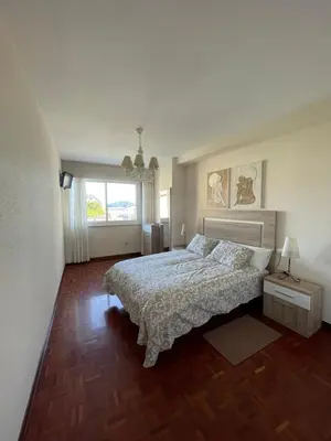 a bedroom with a bed and a large window at SOL Y MAR in Vivero
