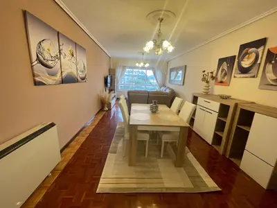 a living room with a table and a kitchen at SOL Y MAR in Vivero