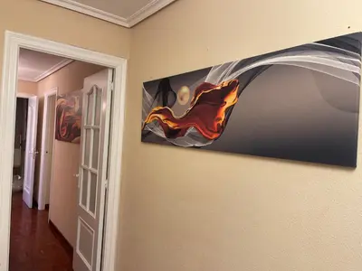 a painting hanging on a wall in a room at SOL Y MAR in Vivero