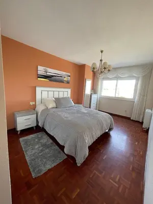 a bedroom with a large bed with orange walls at SOL Y MAR in Vivero