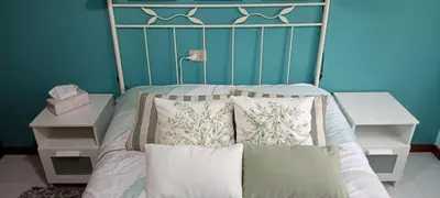 a bed with a metal headboard and pillows on it at EnFOZ SuperAlojamiento Entre Playas in Foz