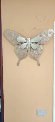a butterfly decoration on the wall of a room at EnFOZ SuperAlojamiento Entre Playas in Foz