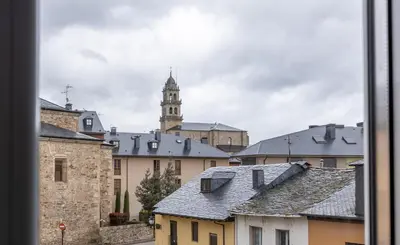 a view of roofs of buildings with a clock tower at Nômada Castillo _ VUT-LE-251 in Ponferrada