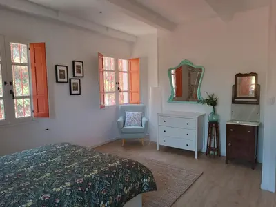 a bedroom with a bed and a dresser and a mirror at O Salgueiral in Castro Caldelas