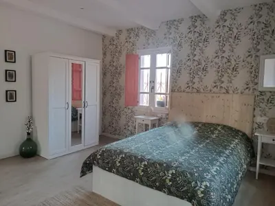a bedroom with a large bed and a window at O Salgueiral in Castro Caldelas