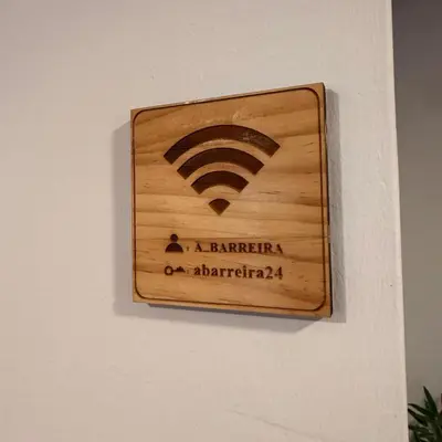 a wooden sign on a wall with a wifi symbol at A Barreira in Ferrol