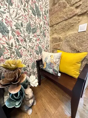 a living room with a couch and a yellow pillow at El nido del cuco in Padrón