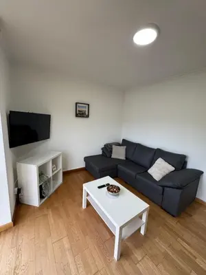 a living room with a couch and a coffee table at PortoHome 1 in Portomarin
