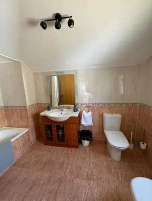 a bathroom with a toilet and a sink and a mirror at PortoHome 1 in Portomarin