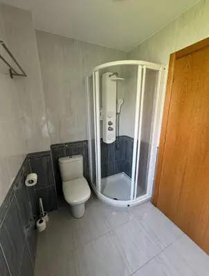 a bathroom with a shower with a toilet and a shower at PortoHome 1 in Portomarin