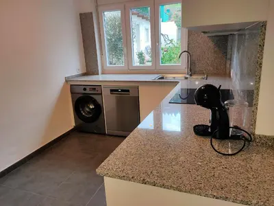 a kitchen with a washing machine on a counter at Altamira in Viveiro