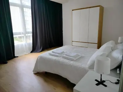 a bedroom with a white bed and a large window at Altamira in Viveiro