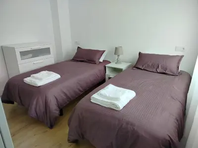 two beds sitting next to each other in a room at Altamira in Viveiro