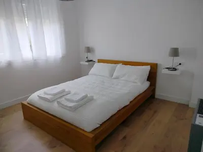 a bed with white sheets and pillows in a bedroom at Altamira in Viveiro