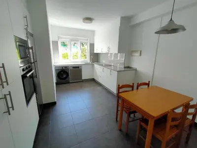 a kitchen with a table and a table and chairs at Altamira in Viveiro