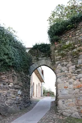 an archway in a stone wall with an alley at Delta in Monforte de Lemos