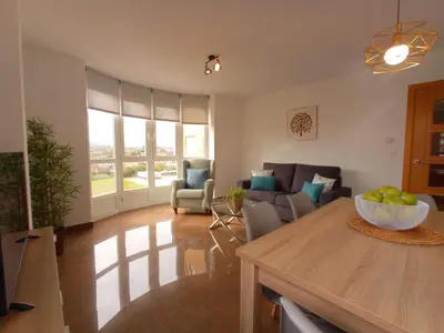 a living room with a table and a couch at Delta in Monforte de Lemos