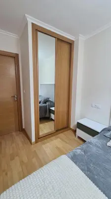 a bedroom with a large mirror and a bed at Piso Vega Foz in Foz