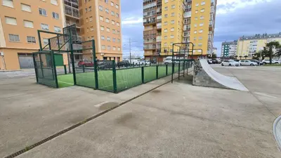a skate park with a ramp in a parking lot at Piso Vega Foz in Foz