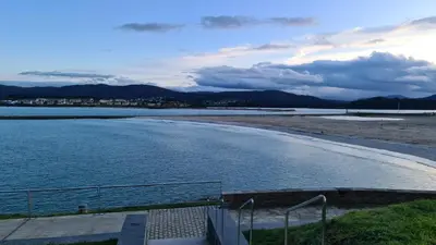 a body of water with a beach and a city at Piso Vega Foz in Foz