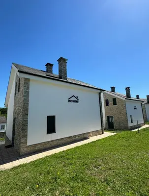 a large white building with a sign on the side at PortoHome 2 in Portomarin