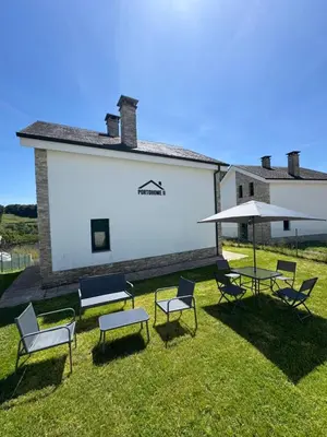 a group of chairs and tables in a yard at PortoHome 2 in Portomarin