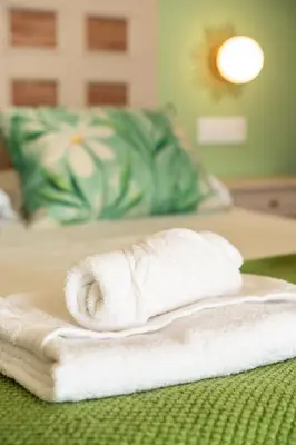 a stack of towels sitting on a bed at A Casa da Carminha, Ribeira Sacra in Pereiro de Aguiar
