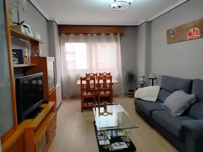 a living room with a couch and a tv at PONFETEMPLE in Ponferrada