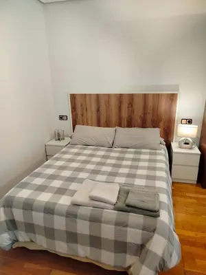 a bedroom with a bed with two towels on it at PONFETEMPLE in Ponferrada