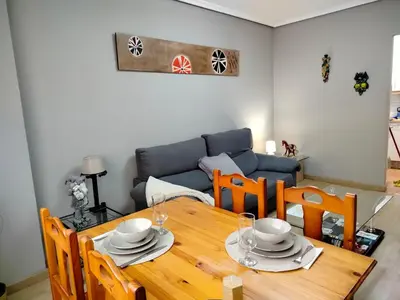 a dining room with a table and a couch at PONFETEMPLE in Ponferrada
