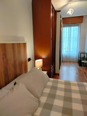 a bedroom with a large bed with a checkered floor at PONFETEMPLE in Ponferrada