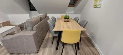 a dining room with a wooden table and chairs at Temple I in Ponferrada