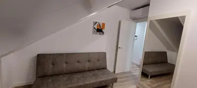 a living room with a couch and a mirror at Temple I in Ponferrada