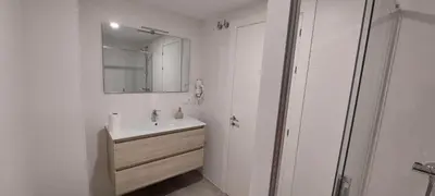 a white bathroom with a sink and a mirror at Temple I in Ponferrada