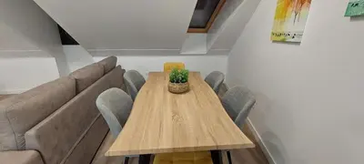 a dining room table with chairs and a couch at Temple I in Ponferrada