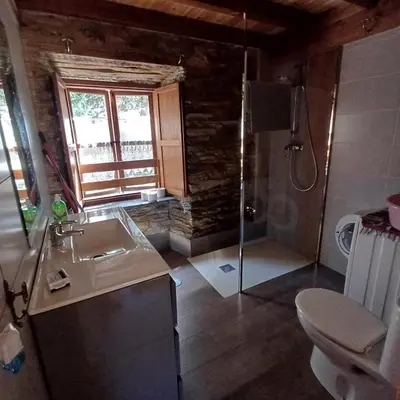 a bathroom with a shower and a sink and a toilet at Casa Fernanda Viavélez in El Franco
