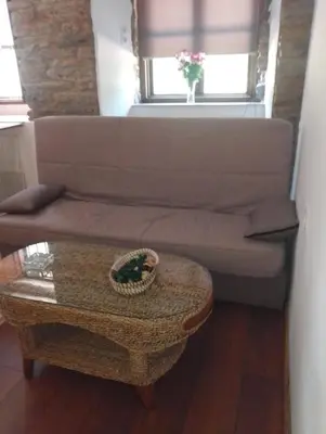 a living room with a couch and a table at Casa Fernanda Viavélez in El Franco