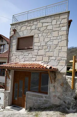 a stone building with a window and a roof at Casa Larán in Chantada
