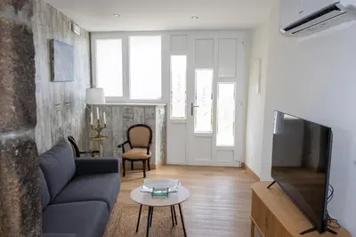 a living room with a couch and a tv at Casa Larán in Chantada